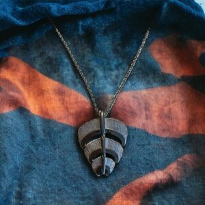 Vintage Lisner 1970’s articulated pendant, silver tone.